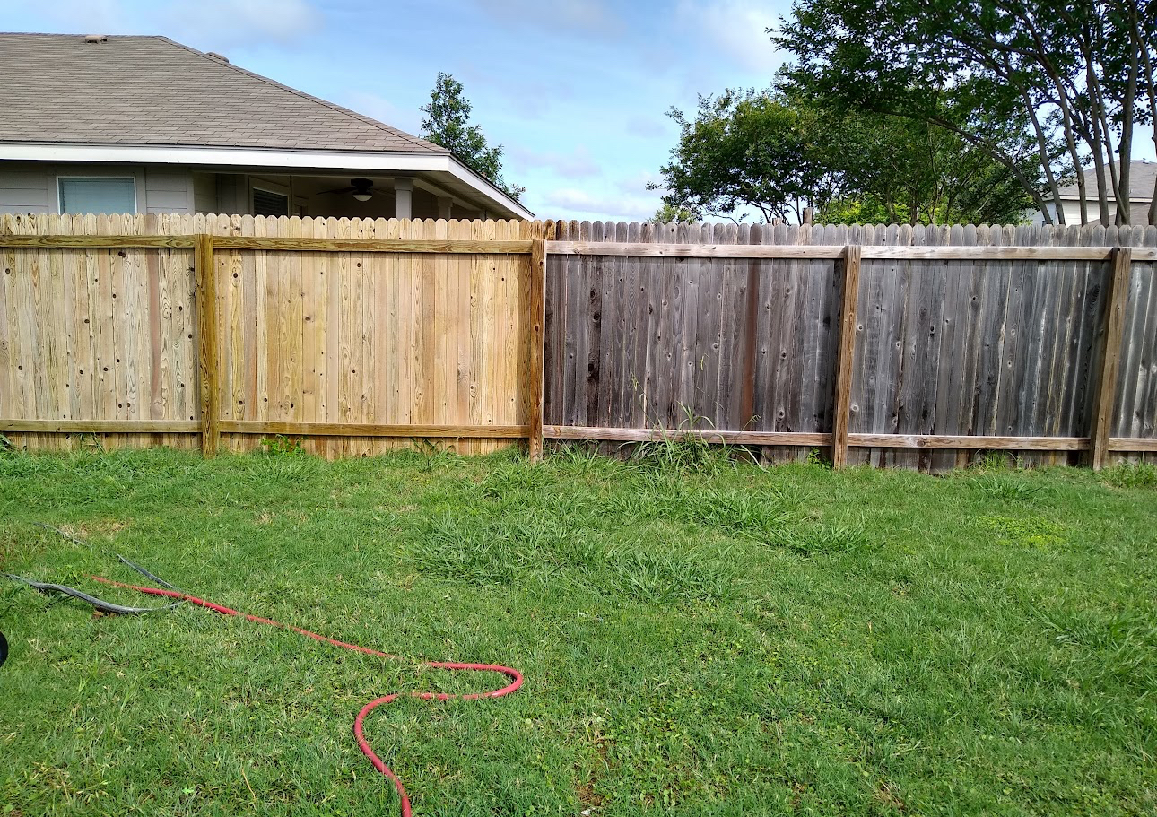 Side-by-side fence panels showing weathered wood next to freshly cleaned and stained sections